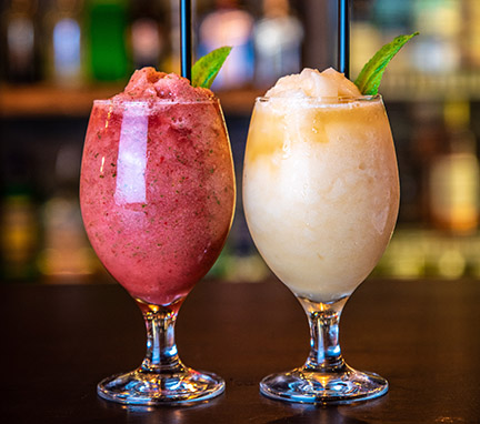 Two wine slushies on the bar counter.
