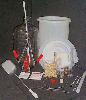 Basic winemaking equipment, including a glass carboy and plastic pails.