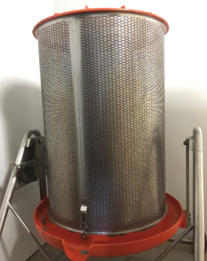 A bladder press has a bladder in the middle that is filled with water to press the grapes outward against the stainless steel basket.
