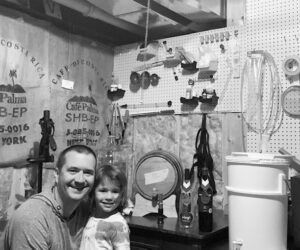 Author Jesse McClain and his 6-year-old daughter in their home winery cellar