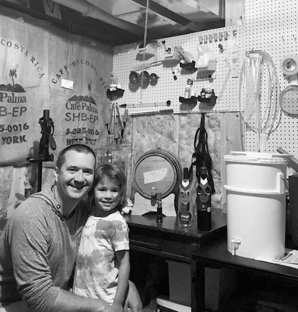 Author Jesse McClain and his 6-year-old daughter in their home winery cellar
