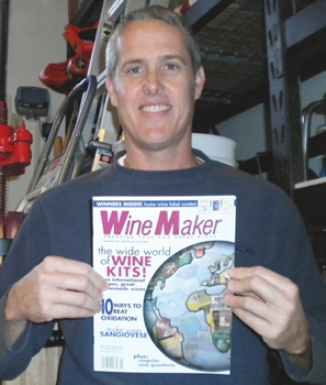 Man holding a copy of WineMaker magazine.