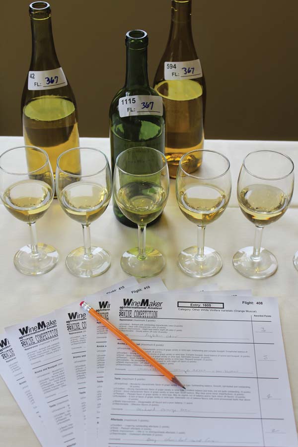A flight of 5 white wines and their respective judging sheets