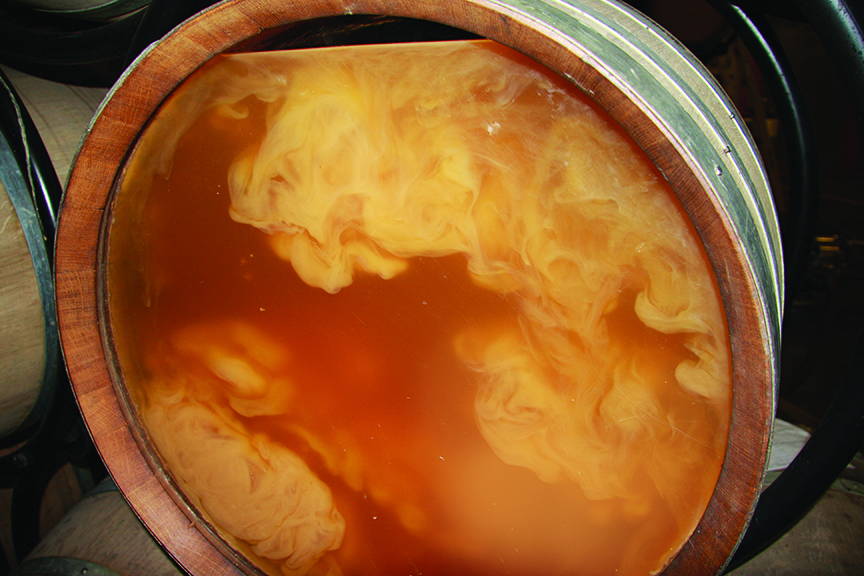 wine lees stirred in a barrel.