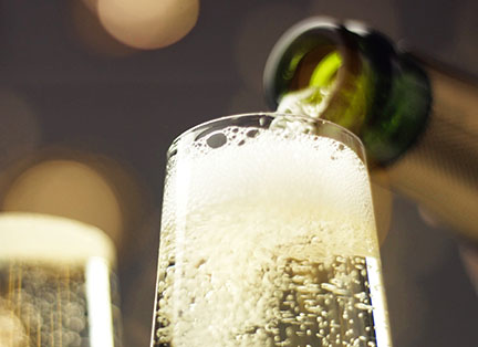 sparkling wine being poured into a glass