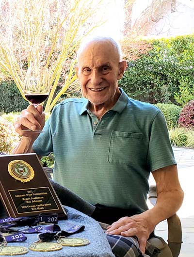 Winemaker Rex Johnson with his numerous awards from amateur competitions