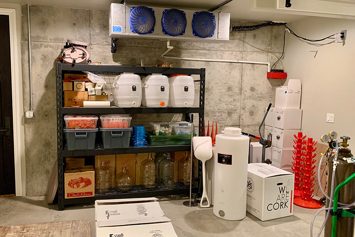 Shelf with organized winemaking equipment.